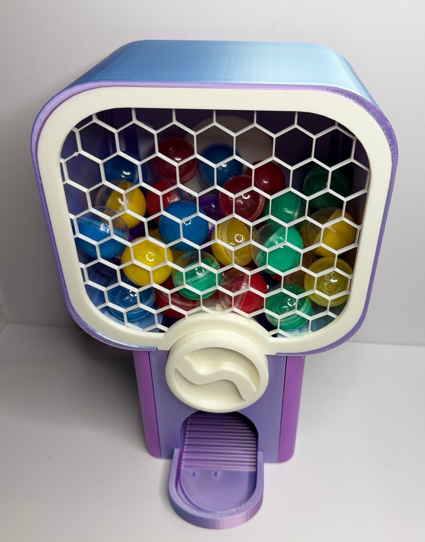 Close up of 3D printed vending knob and capsule dispenser mechanism